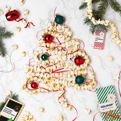 a christmas tree made out of popcorn and other holiday decorations on a marble counter top