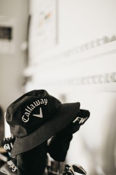 a black and white photo of a hat sitting on top of a bike rack in a room