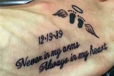 a person with a tattoo on their chest saying, never in my arms always in my heart