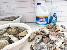 clams in a bowl next to a bottle of cleaner