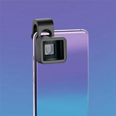 a camera attached to the back of a cell phone in front of a purple and blue background