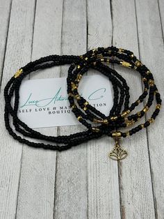 🌼🖤 Elevate your self-love and manifestation journey with our Black & Gold Waist Beads featuring a delicate Lotus Charm! 🖤🌼 ✨ Handcrafted with care and attention to detail, these exquisite waist beads combine the timeless elegance of black and gold. The lotus charm adds a touch of spiritual symbolism, representing growth, purity, and transformation. This waist chain is a perfect gift for her or a special treat for yourself. ⚡️ Designed to stretch comfortably and featuring a secure clasp, thes Adjustable Spiritual Waist Beads, Adjustable Hand-strung Spiritual Waist Beads, Spiritual Jewelry With Tiny Beads For Meditation, Adjustable Holistic Jewelry For Yoga, Adjustable Black Beads Jewelry For Meditation, Gold Waist Beads, Waist Jewelry, Money Manifestation, Waist Beads