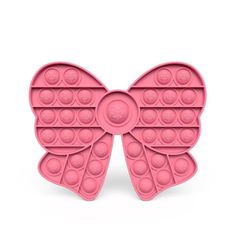 a pink butterfly shaped cake pan with circles on it's wings and the shape of a