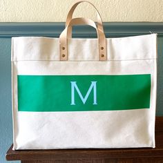 Our best-selling leather handle canvas tote personalized with a sleek wide stripe and initials (or name, or school!). Another great option for a housewarming, wedding, or graduation gift. Or just nab one for yourself and carry it to work in style. Please pick a stripe color and leave a note white your initial color choice. Coordinates with our wide stripe zip top! 14"h x 18"w x 8.25"d. Leather handles with 5" drop. Open top with two inside pockets. Ivory: 20oz canvas. Colors: 18oz canvas. Vinyl Navy Bag, Canvas Leather Bag, Vinyl Monogram, Gift Business, Wide Stripes, Monogram Styles, Custom Monogram, Canvas Leather, Vinyl Colors