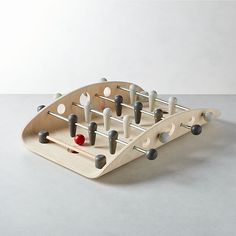 a wooden toy with several pegs in it