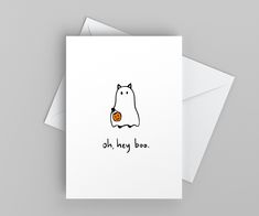 a white card with an image of a cat holding a pumpkin in it's mouth