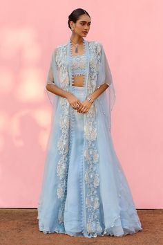 Powder blue asymmetric cape with embroidered floral jaal motifs highlighted by pearls and beads. Comes with bead embroidered blouse and tiered hem lehenga. - Aza Fashions Designer Cape Sets With Sheer Dupatta, Blue Anarkali Dress For Ceremony, Sheer Dupatta Cape Set For Reception, Festive Lehenga With Sheer Dupatta And Cape, Reception Cape Set With Sheer Dupatta, Blue Anarkali Set With Cape Sleeves, Blue Lehenga With Cape Sleeves And Dupatta, Organza Lehenga With Cape Sleeves For Wedding, Cape Lehenga With Dupatta For Reception