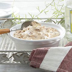 a white bowl filled with food on top of a table