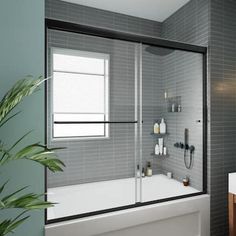 a bathroom with a tub, sink and shower in it's center wall is shown