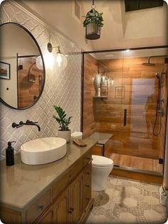 a bathroom with a sink, toilet and shower stall in it's own area