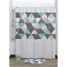 a bathroom with a shower curtain and rug