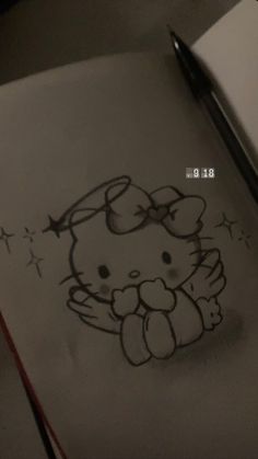 a drawing of a hello kitty with stars on it's head is shown next to a pen