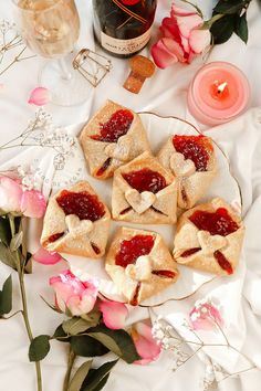 small pastries on a plate with flowers and candles