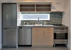 a kitchen with stainless steel appliances and cabinets