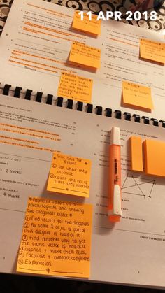 yellow sticky notes are on top of a white paper with black writing and orange marker