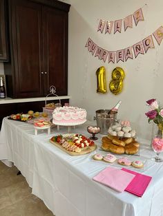 a table topped with lots of cakes and desserts