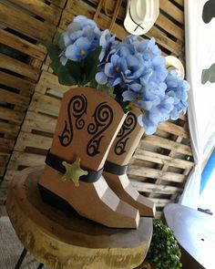 a pair of boots with blue flowers in them