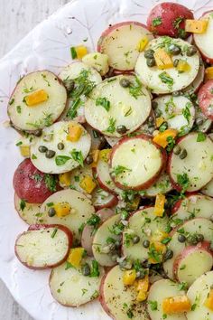 a white plate topped with sliced up radishes covered in herbs and seasoning