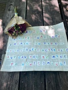 flowers are placed on top of an old newspaper that has been written in multiple languages