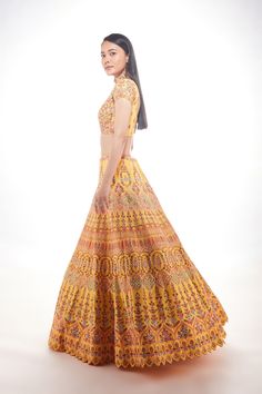 A yellow silk lehenga with fine multi-hued resham embroidery with a touch of sequins and glass beads paired with a matching blouse and mauve pink net dupatta From Chamee and Palak 's The Wedding Edit collectionDELIVERY TIMEPlease allow 8-12 weeks for your outfit to arrive.FABRIC DETAILSSilk And NetProfessional cleaning only. Yellow Raw Silk Traditional Wear With Mirror Work, Designer Yellow Anarkali Set With Intricate Embroidery, Yellow Raw Silk Anarkali Set With Mirror Work, Yellow Traditional Wear With Mirror Work In Raw Silk, Yellow Raw Silk Set With Mirror Work, Designer Yellow Chanderi Choli, Yellow Chanderi Traditional Wear For Reception, Yellow Silk Sets With Intricate Embroidery, Yellow Silk Set With Intricate Embroidery