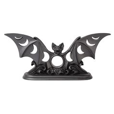 a candle holder with a bat design on it