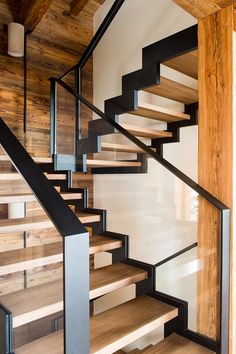 a wooden staircase with metal handrails in a house