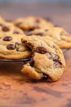 chocolate chip cookies on a plate with the words brown butter chocolate chip cookies above them