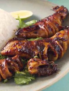 chicken and rice on a plate with garnishes