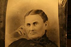 an old black and white photo of a woman