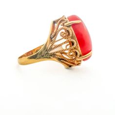 Vintage Coral Art Deco Style Cocktail Estate 14K yellow gold ring with a captivating coral gemstone. It combines vintage charm with Art Deco style, making it a stunning choice for special occasions.14K Yellow Gold Red Coral 14tcw ( 17.3mm x 12.2mm )Size 6.5 Resize available Thank you for visiting our shop!Visit our website DmKJewelry.comAlso Follow us on Instagram https://www.instagram.com/dmkjewelryny/ Elegant Red Intaglio Signet Ring, Red Intaglio Rings For Anniversary, Vintage Yellow Gold Carnelian Ring, Vintage Carnelian Yellow Gold Ring, Vintage Carnelian Ring For Formal Occasions, Elegant Round Carnelian Signet Ring, Elegant Carnelian Rings For Wedding, Elegant Gold Signet Ring With Carnelian, Elegant Yellow Gold Carnelian Ring