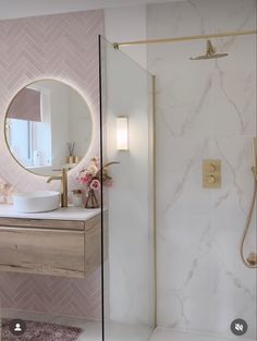 a bathroom with a shower, sink and mirror on the wall next to each other