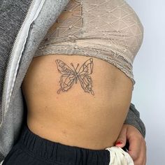 a woman with a butterfly tattoo on her stomach