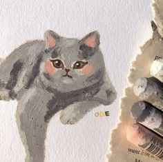 a drawing of a cat on paper next to crayons