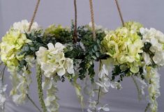 some white and green flowers hanging from strings