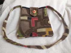 This handcrafted bag is made from the finest tapestry with a rich pile. It is lined with silk fabric and features 2 pockets inside with zippers.      The strap is 49 inches long, over the shoulder strap.  The purse is approximately 12 inches wide at its widest point, 9 inches wide at its narrowest point and 10 inches deep. Tapestry Handbags, Handcrafted Bags, New Holland, Purse Bag, Silk Fabric, Inside Pocket, Purses And Handbags, Burlap Bag, Holland