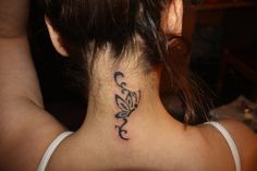 a woman with a tattoo on her back neck