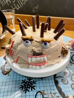 a cake decorated to look like a hedgehog with chocolate sticks sticking out of it's mouth