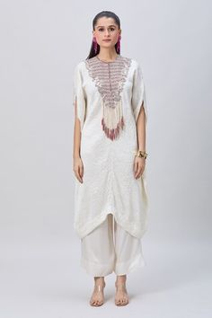 Ivory crushed kaftan with silver dori work embellished yoke and tassel details. Comes with solid pant. - Aza Fashions White Floor-length Kaftan For Festive Occasions, Festive Floor-length White Kaftan, Festive White Floor-length Kaftan, Floor-length White Kaftan With Resham Embroidery, White Floor-length Kaftan With Resham Embroidery, White Resham Embroidery Floor-length Kaftan, White Embellished Thobe For Eid, Festive Embellished White Kaftan, Festive White Embellished Kaftan