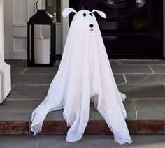 a white ghost is standing in front of a door