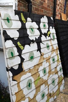 wall of shed half painted with the Marimekko unikko print Shed Diy, Town Garden, Painted Shed, Honeycomb Tile, Dry Brush Painting, Shed Makeover, Garden Mural, Gallon Of Paint, Brick Paneling