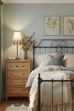 a bedroom with a bed, dresser and two pictures on the wall above it's headboard