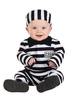 a baby in a jail suit sitting on the ground