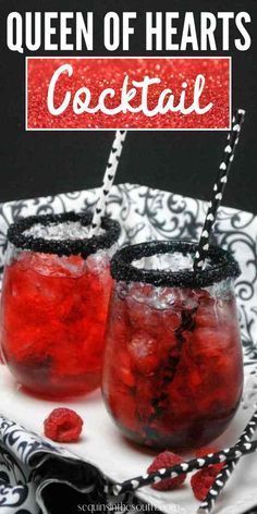 two glasses filled with red liquid sitting on top of a white plate