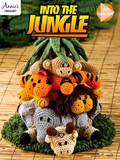 a group of stuffed animals sitting on top of each other in front of a plant