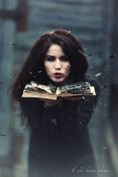 a woman holding an open book in her hands