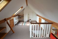 an attic bedroom with stairs leading up to the loft