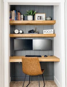 a desk with a computer on top of it in front of a book shelf filled with books