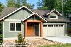 a house with two garages in the front and one on the side, surrounded by trees