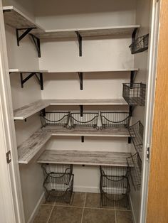 an empty walk in closet with shelves and baskets