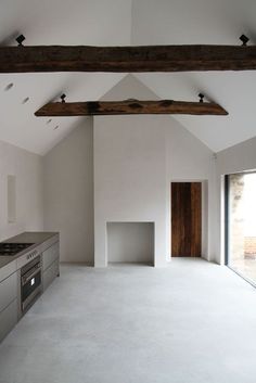 an empty kitchen with white walls and flooring is pictured in this image from the inside